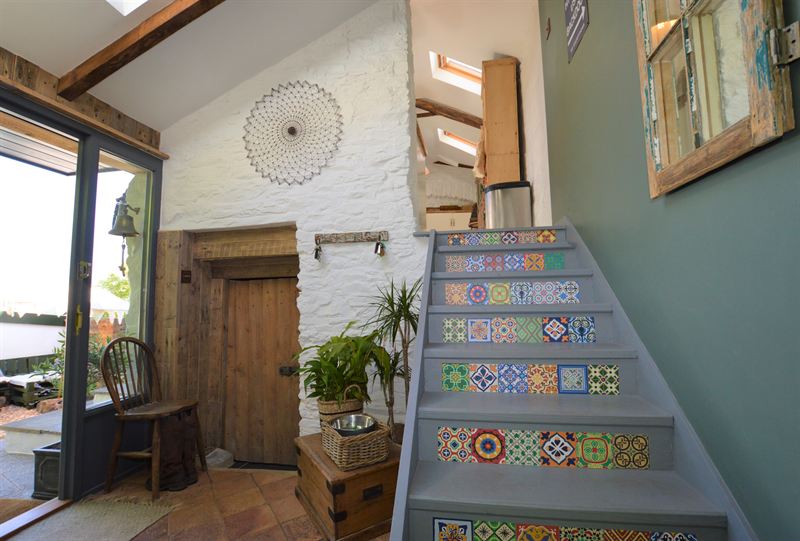 Porch with painted stairs and patterned tile risers